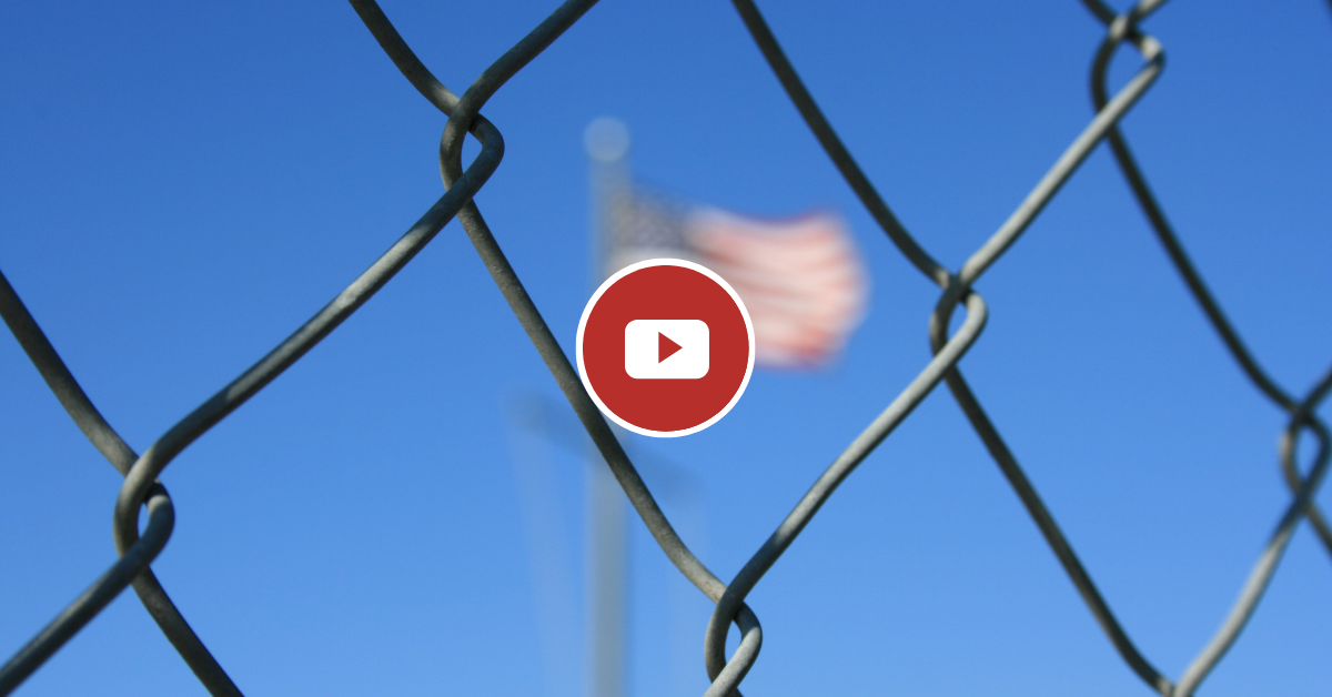 American Flag behind a chain link fence